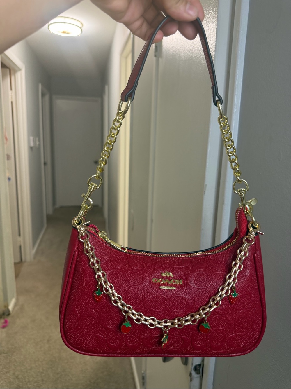 Coach Red Leather Shoulder Bag with Gold Chain and Charm Accents